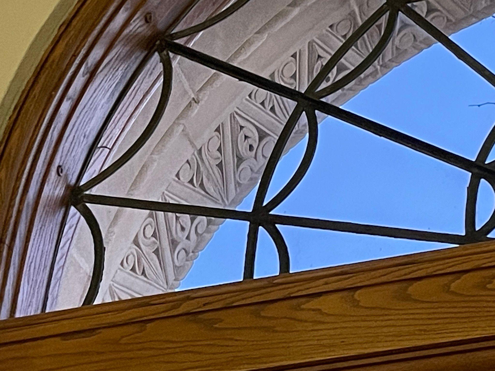 Photograph of the semicircle window above the library's exterior entrance doors.