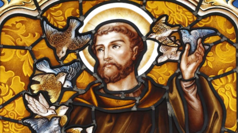 Photo of St. Francis with birds on a stained glass window.