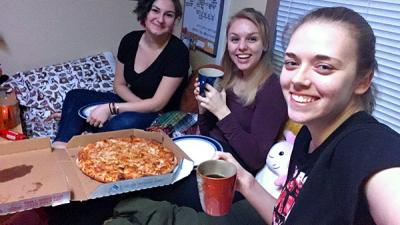 Girls in dorm having pizza