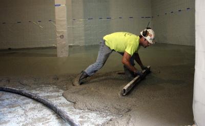 The strength training room in the Varsity Athletic Center was expanded this summer into two former racquetball courts. The concrete floor was poured in mid-July and the rubber floor will be installed before classes start.