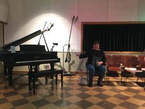 Nancy Allen, director of Viterbo University’s Platinum Edition show choir, is pictured with the historic piano she got to play when the choir had a recording session in RCA Studio B in Nashville.