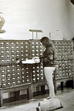 Student using the card catalog in the library.