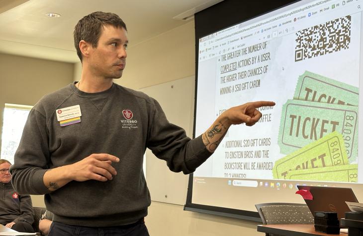 Cameron Kiersch explains the finer points of the recent campus climate challenge at Viterbo to the university’s Employee Assembly. Students, faculty and staff got involved in an activity to track and reduce their impacts on planetary health.