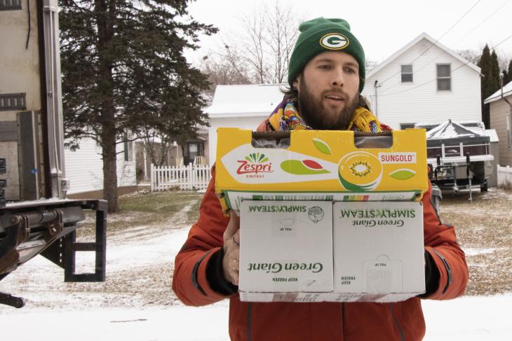 A former Viterbo basketball player, house coordinator Alex Diciaula unloads food items for the Place of Grace pantry from the Hunger Task Force truck, which comes every Tuesday just before the pantry opens for visitors. 