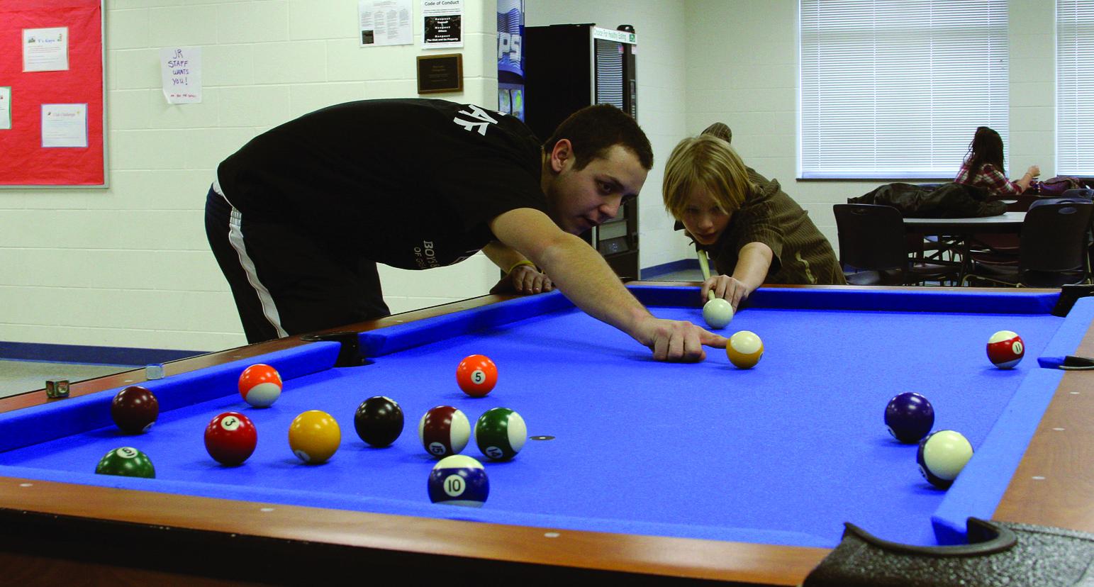 Playing pool at the Mathy Center Boys & Girls Club