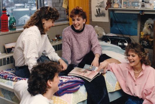 Students socializing in a dorm room in the late 1980s.