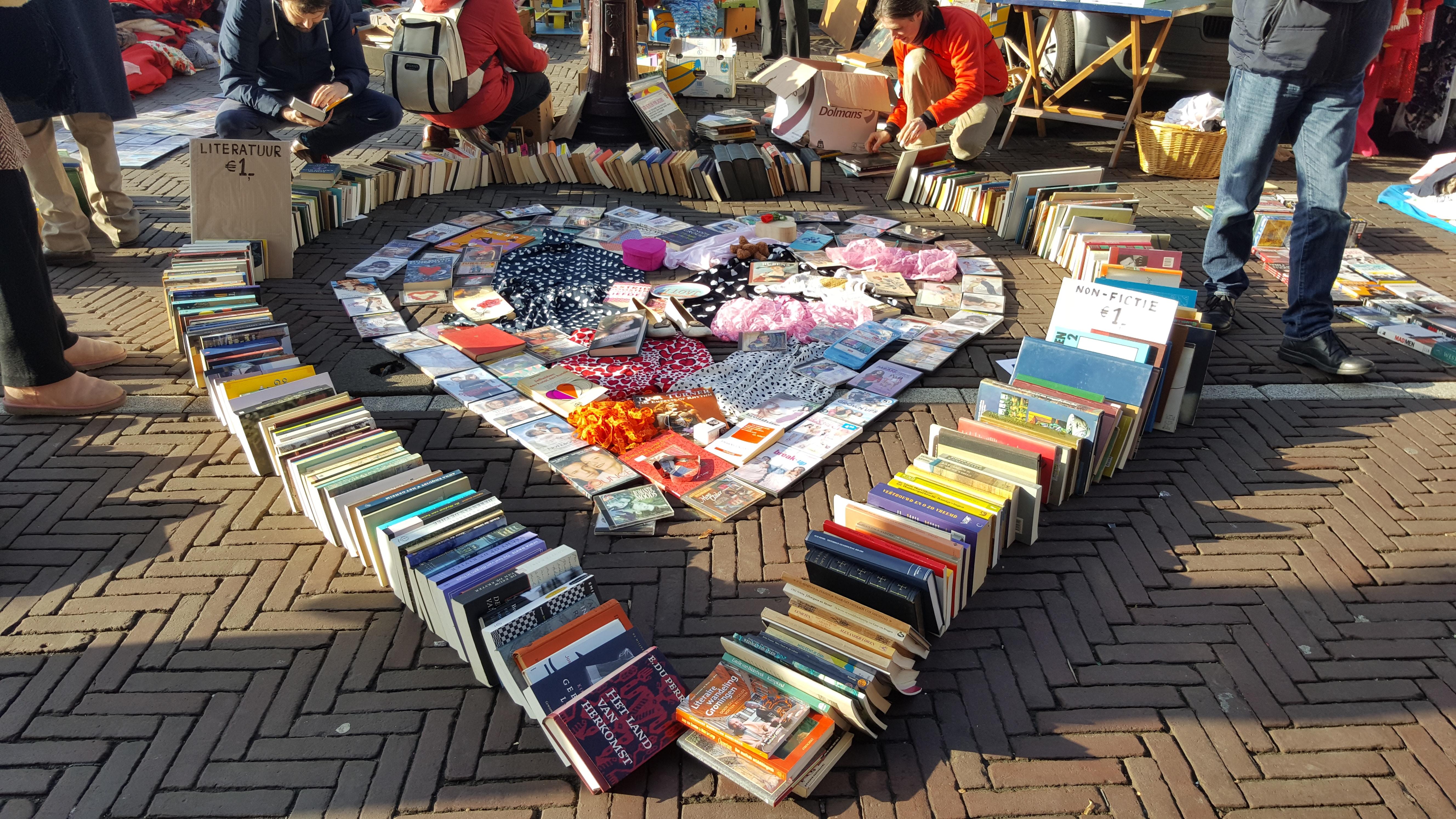 Heart shape made out of books on sidewalk