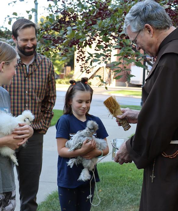 Priest blessing animal