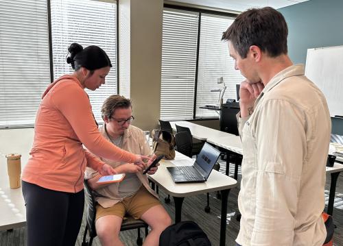 Lyza Hoscheit, Dylan Woodman and Cameron Kiersch, from left, prepare to go out and recruit students, faculty and staff participation in a campus climate challenge.