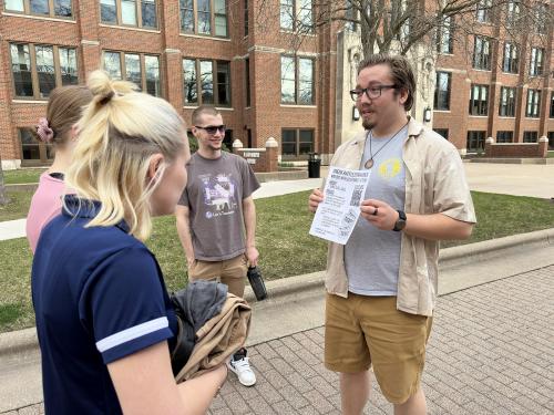 Dylan Woodman makes a pitch for climate challenge participation to Viterbo staff members. 