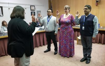 Juan Jimenez, right, is sworn in as a member of the La Crosse School Board in April 2019.