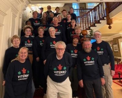 Large group of people on a staircase wearing Viterbo University tshirts