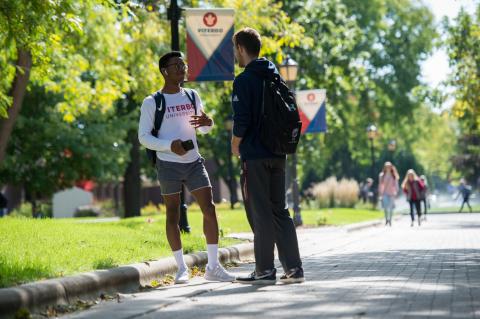 Two Viterbo male students standout outside on a summer day. 