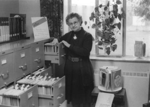 Sister Lillian Schmitt cataloging documents in the library, year unknown.