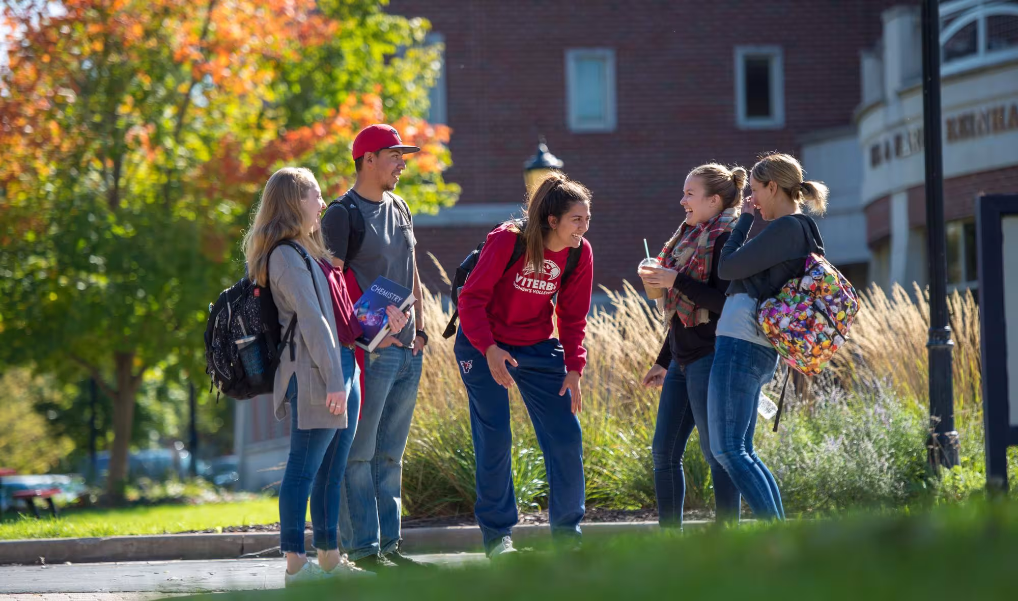 Students on campus talking in fall season