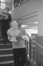 President Robert Gibbons walking the bust of Shakespeare to its new home on the first floor.